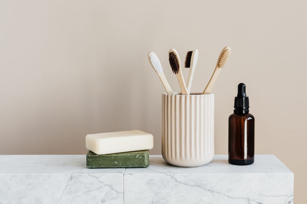 An elegant image of toothbrush holder and soap, neatly placed on a bathroom counter.