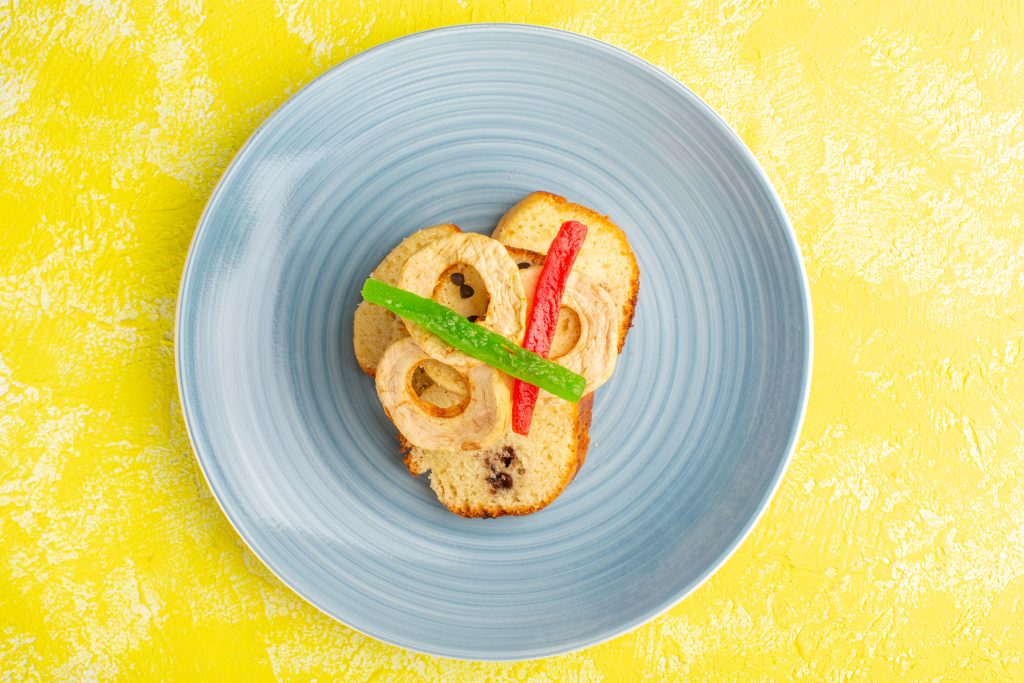 A plate with sliced bread and peppers, showing how serving slightly less can reduce your calorie intake.