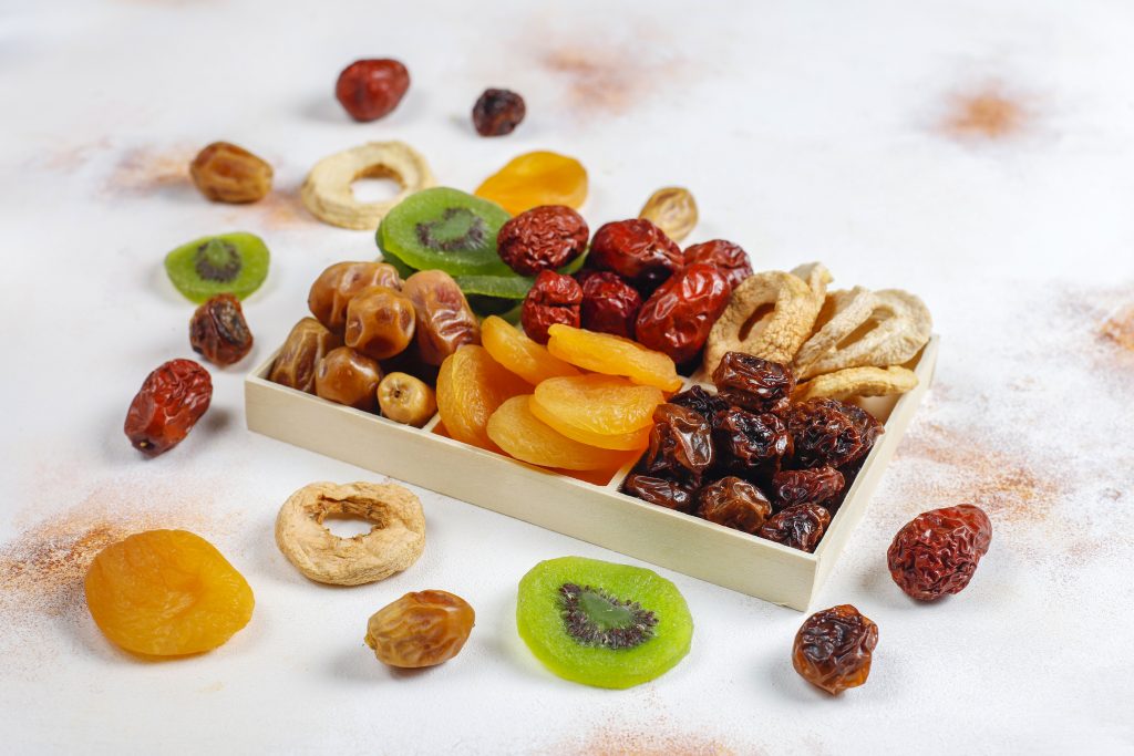 Various nuts on a plate and scattered, highlighting foods naturally rich in iron, including fortified products.