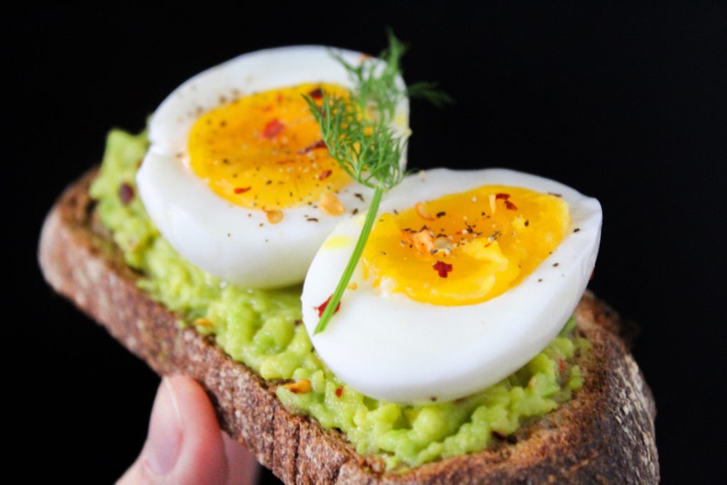 Two halves of a boiled egg with red pepper flakes, highlighting the role of protein in weight loss.