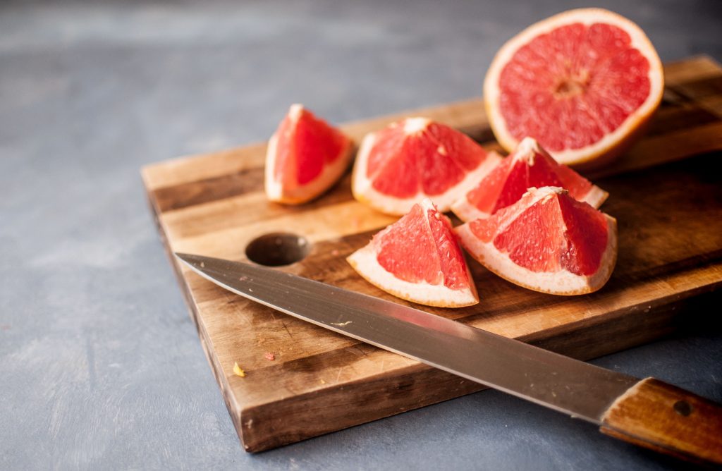 Red grapes with a cut, helping to spark your body's fat-burning ability while providing a healthy snack.