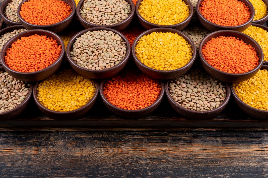 Grains and seeds in small brown bowls, providing zinc to support immune cell growth and maintain healthy hair, skin, and nails.