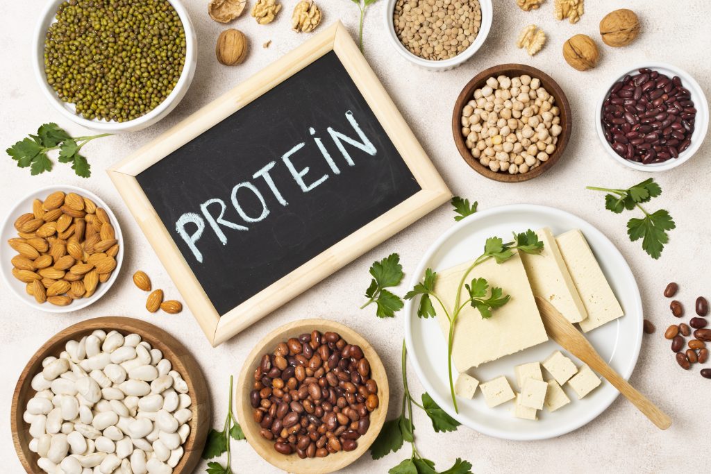 Slate with 'Protein' written on it, surrounded by dal, symbolizing the role of protein in minimizing cravings.