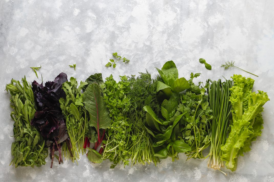 Fresh greens with lettuce, basil, mint, dill, and parsley, providing essential nutrients, including magnesium for a healthy diet.