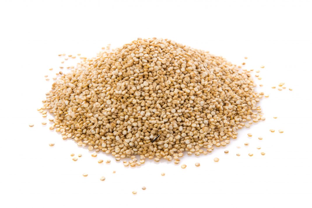 A pile of raw quinoa, a great gluten-free choice for a balanced diet.
