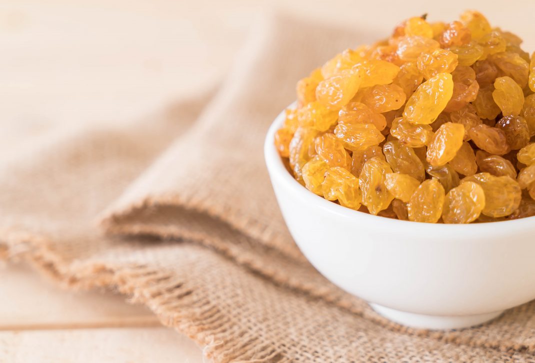 A bowl of raisins, rich in phytochemicals, promoting strong teeth and gums.